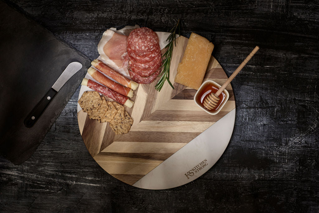 Round premium acacia wood and marble serving board. Charcuterie board with cheese, crackers and meat